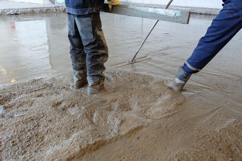 men leveling concretemix on the floor