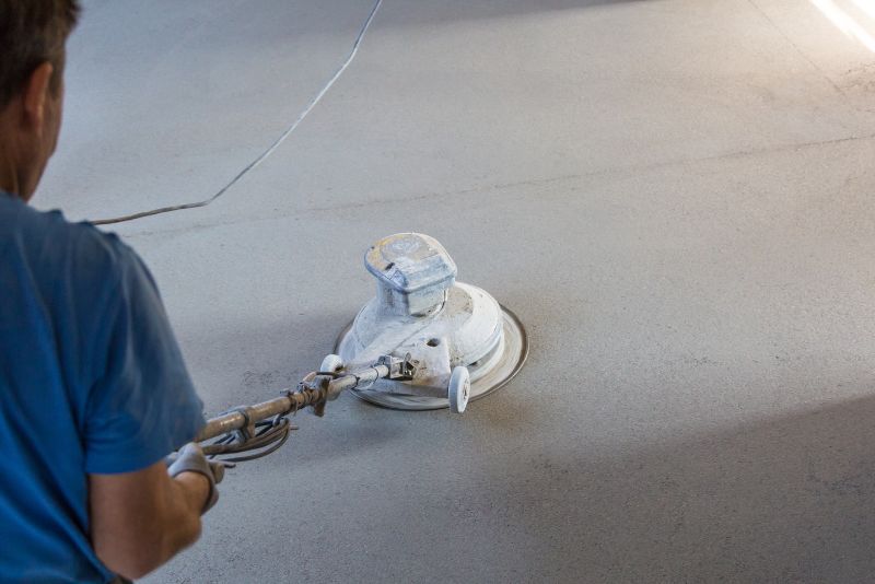 mason using a grinder to polish the concrete floor