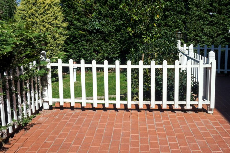 patio with white fence and concrete slabs