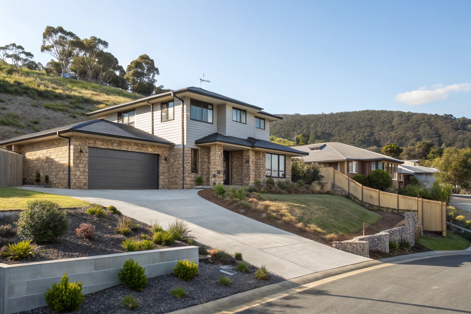 A completed modern Australian suburban home with neat landscaping, driveway, and garage on a gently sloping block